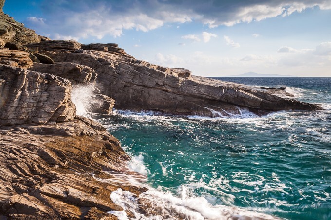 Seascape cliffs of Andros island in Greece